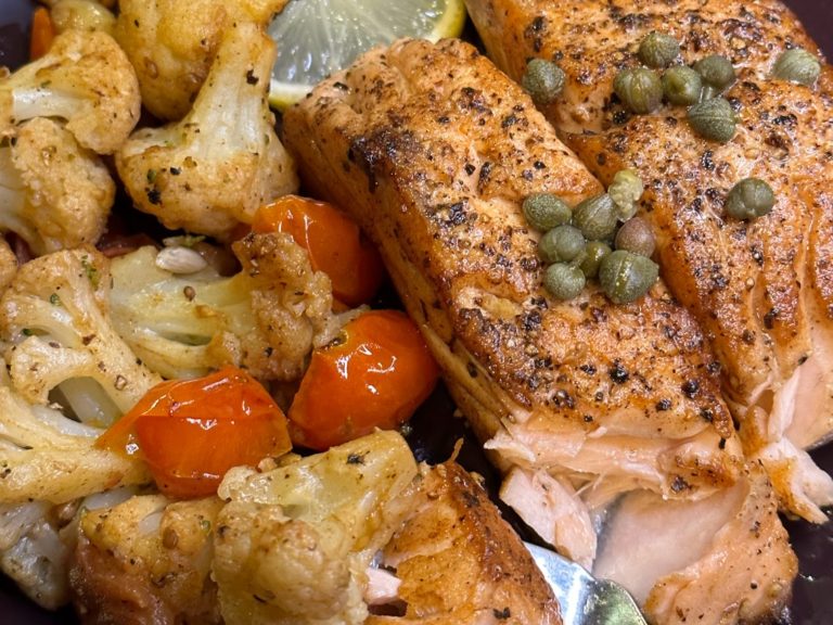 Pan-seared-salmon-with-cauliflower-and-cherry-tomatoes-on-a-plate